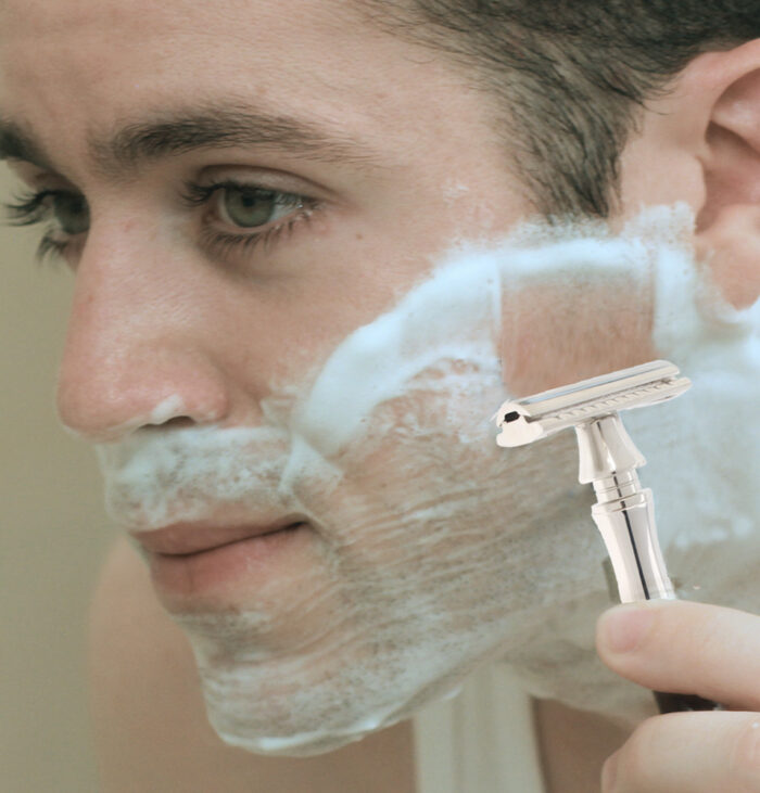 man face close up showing him shaving with eshave double edge razor