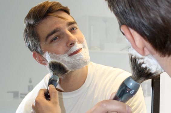 Young Man Applying Shaving Cream with Brush